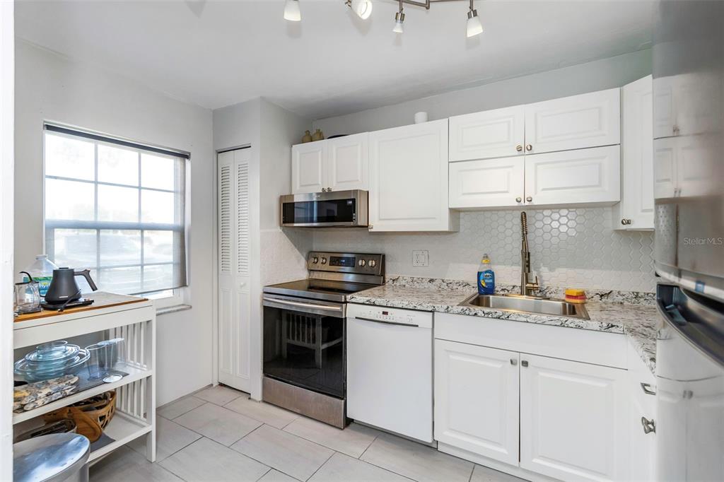 1900 68th Street North, Unit 110 St. Petersburg, FL 33710 - Photo 20 of 48 a kitchen with a sink stove and cabinets