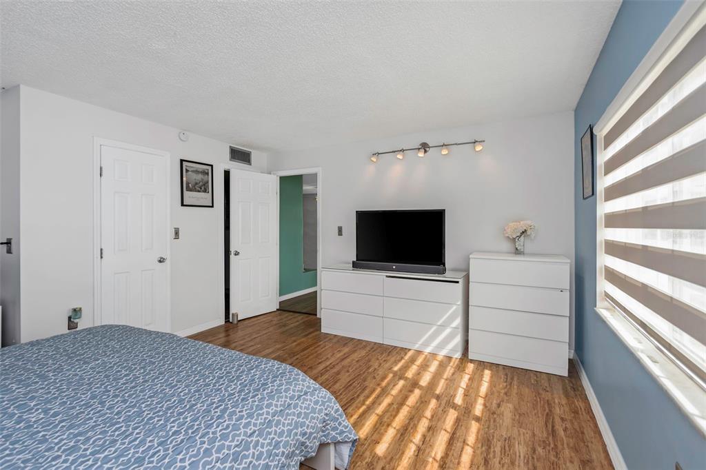 1900 68th Street North, Unit 110 St. Petersburg, FL 33710 - Photo 25 of 48 a bedroom with a bed and a flat screen tv