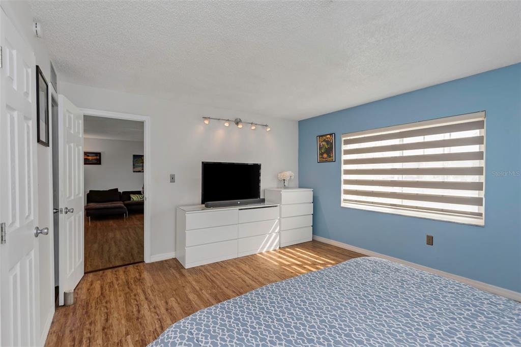 1900 68th Street North, Unit 110 St. Petersburg, FL 33710 - Photo 26 of 48 a bedroom with a bed and a television