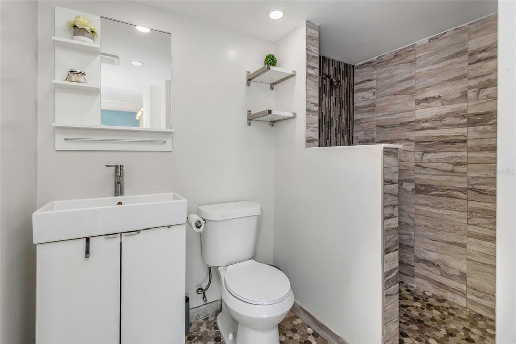 1900 68th Street North, Unit 110 St. Petersburg, FL 33710 - Photo 28 of 48 a bathroom with a sink a toilet and mirror