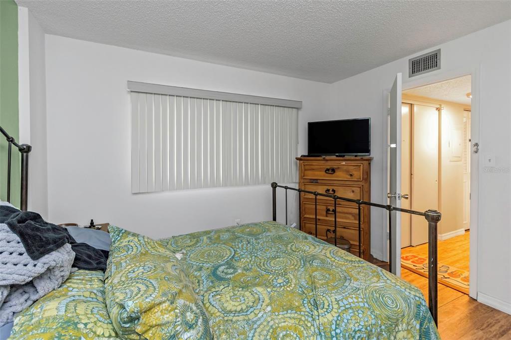 1900 68th Street North, Unit 110 St. Petersburg, FL 33710 - Photo 32 of 48 a bedroom with a bed and flat screen tv