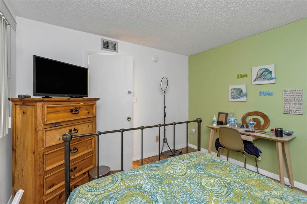 1900 68th Street North, Unit 110 St. Petersburg, FL 33710 - Photo 34 of 48 a bedroom with a bed and flat screen tv