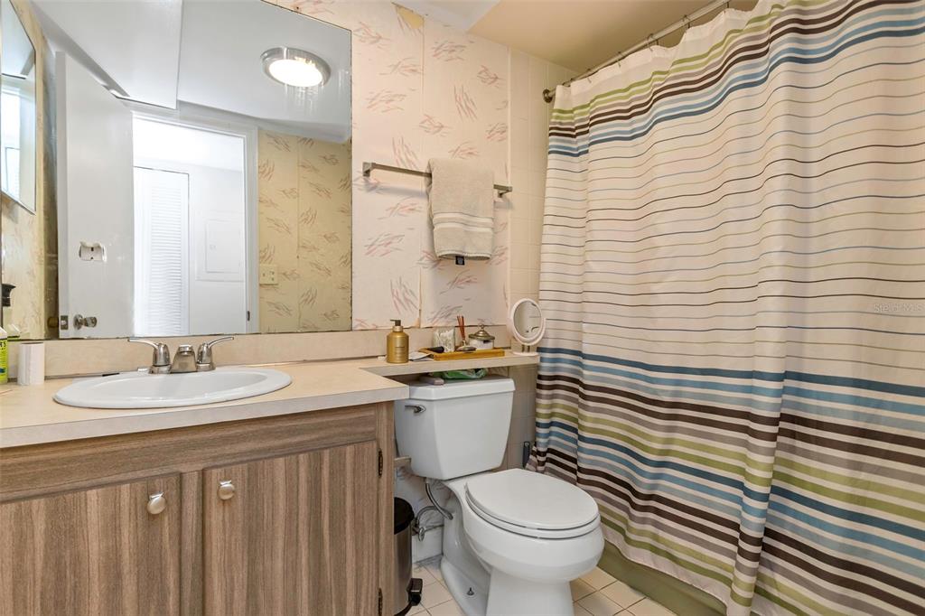 1900 68th Street North, Unit 110 St. Petersburg, FL 33710 - Photo 36 of 48 a bathroom with a sink a toilet and mirror
