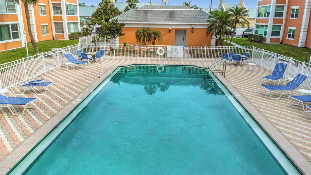1900 68th Street North, Unit 110 St. Petersburg, FL 33710 - Photo 43 of 48 a view of a swimming pool with outdoor seating