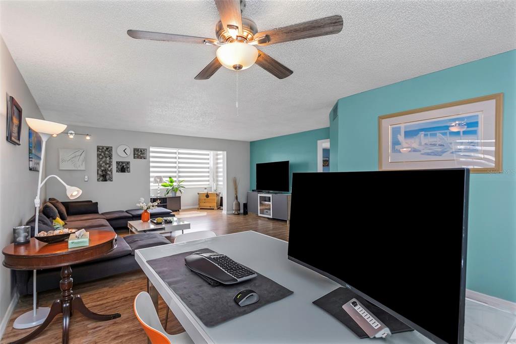 1900 68th Street North, Unit 110 St. Petersburg, FL 33710 - Photo 5 of 48 a living room with furniture and a flat screen tv