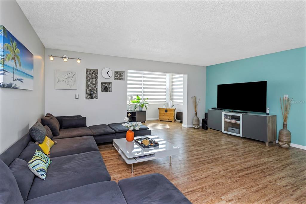 1900 68th Street North, Unit 110 St. Petersburg, FL 33710 - Photo 7 of 48 a living room with furniture and a flat screen tv