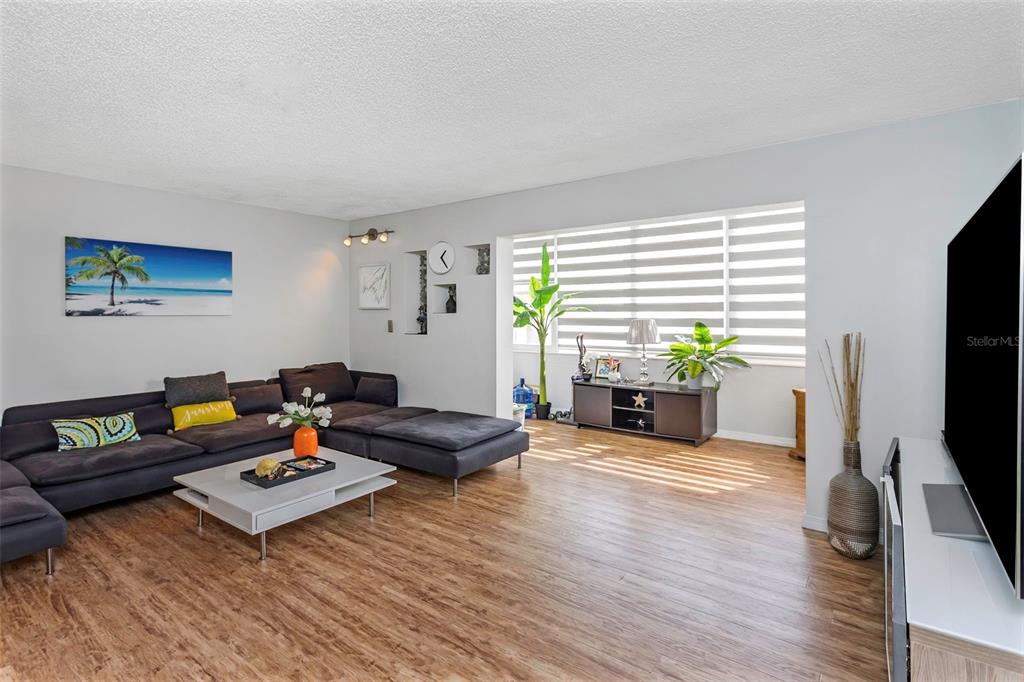 1900 68th Street North, Unit 110 St. Petersburg, FL 33710 - Photo 8 of 48 a living room with furniture and a flat screen tv