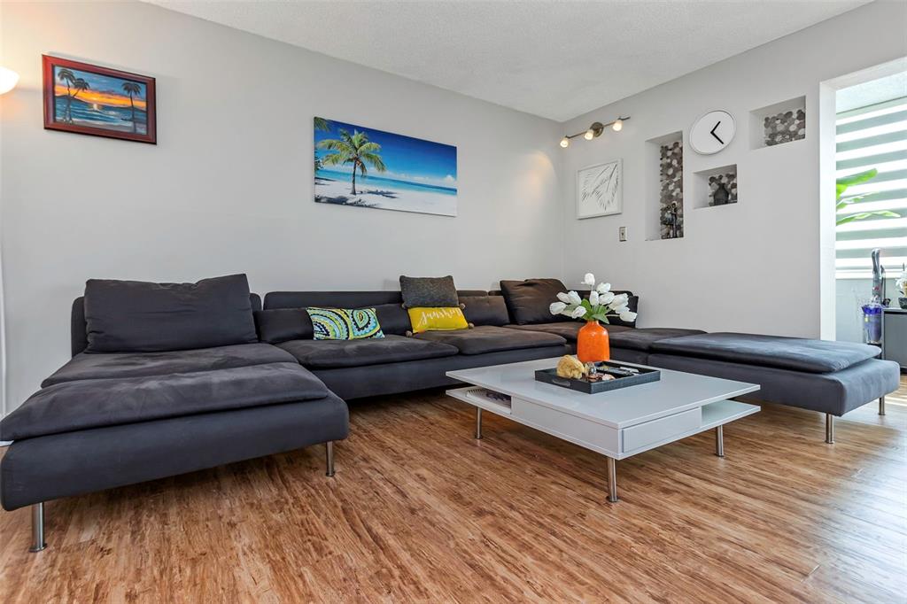 1900 68th Street North, Unit 110 St. Petersburg, FL 33710 - Photo 9 of 48 a living room with furniture and a wooden floor