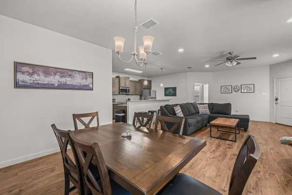 a view of a dining room with furniture and wooden floor