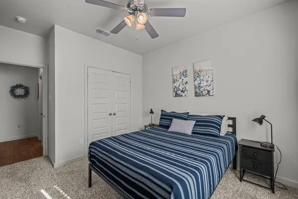 a bedroom with a bed and a chandelier