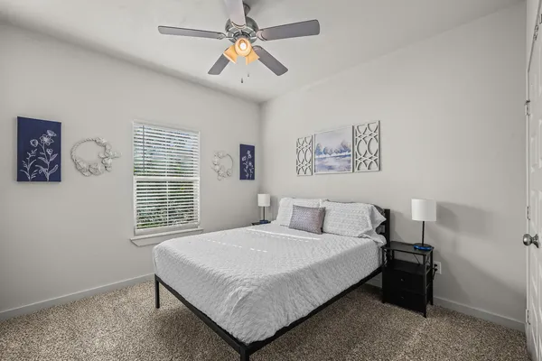 a bedroom with a large bed and a window