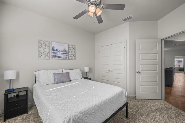 a bedroom with a bed and a chandelier
