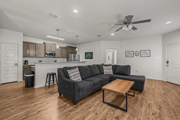 a living room with furniture and kitchen view