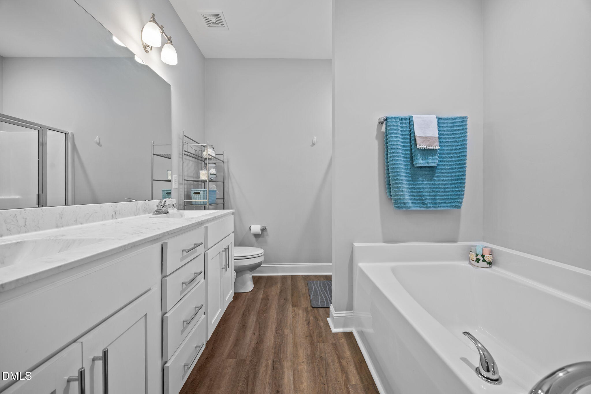 126 Arrow Lane Middlesex, NC 27557 - Photo 17 of 32 a bathroom with a double vanity sink a mirror and a bathtub