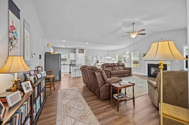 a living room with furniture a fireplace and a flat screen tv