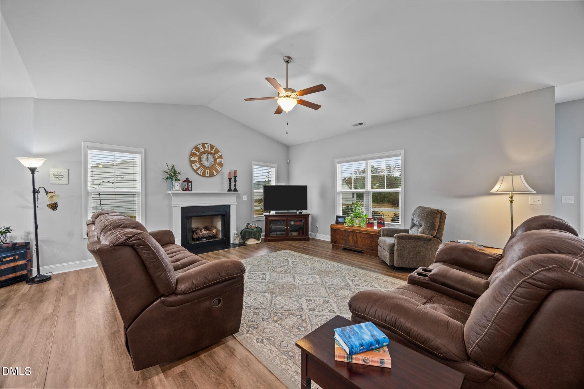 126 Arrow Lane Middlesex, NC 27557 - Photo 5 of 32 a living room with furniture a fireplace and a large window