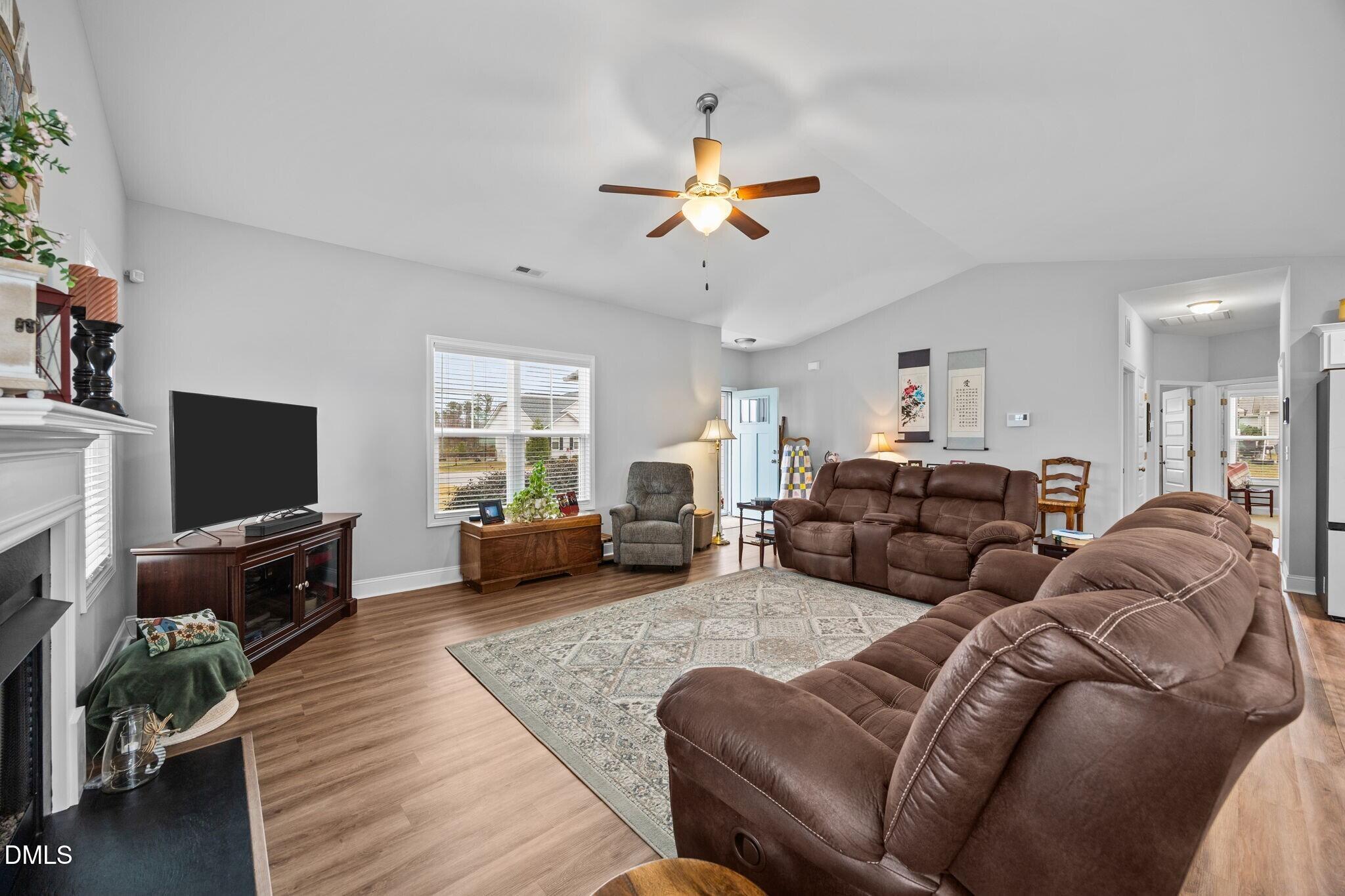 126 Arrow Lane Middlesex, NC 27557 - Photo 6 of 32 a living room with furniture a flat screen tv and a fireplace
