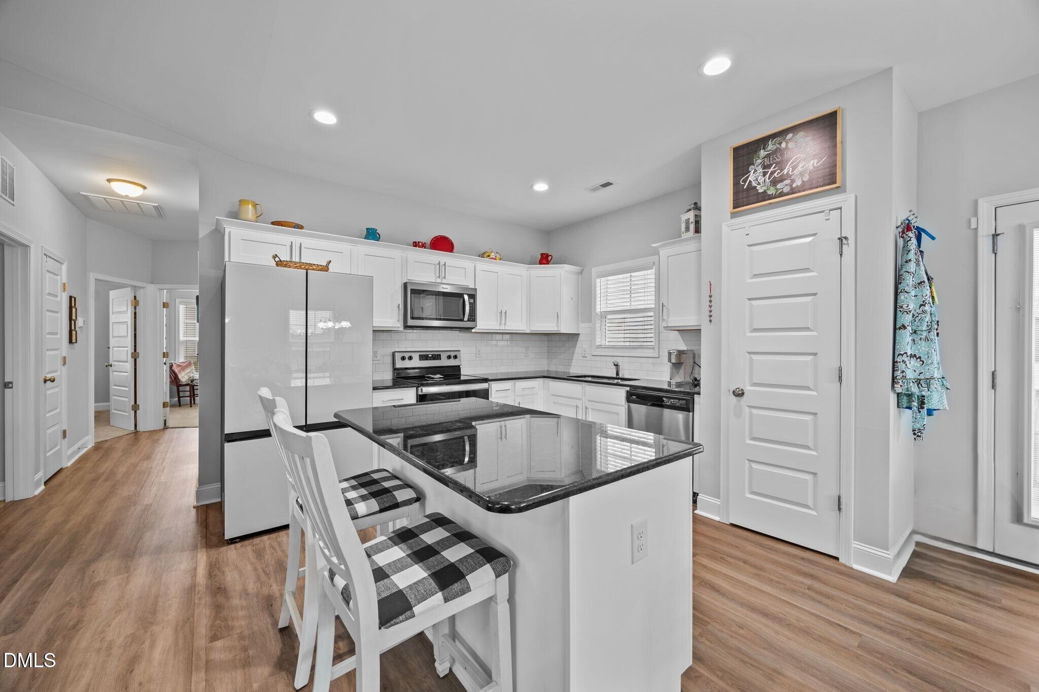 126 Arrow Lane Middlesex, NC 27557 - Photo 7 of 32 a kitchen with granite countertop a refrigerator and a sink