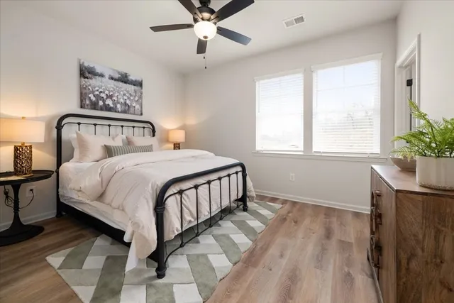 a bedroom with a large bed and a chandelier