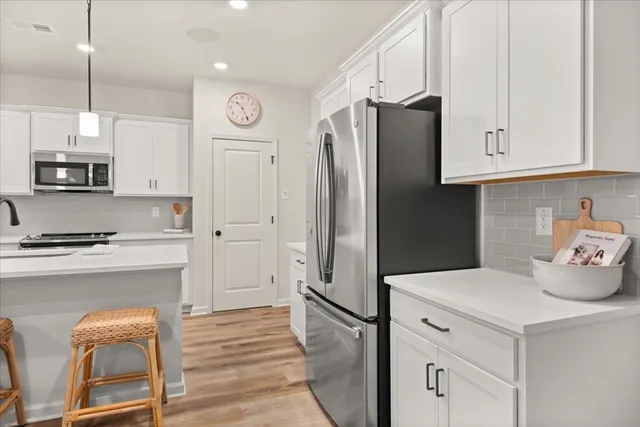 a kitchen with cabinets and a stainless steel appliances