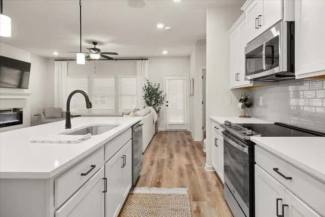 a kitchen with a sink stove and microwave