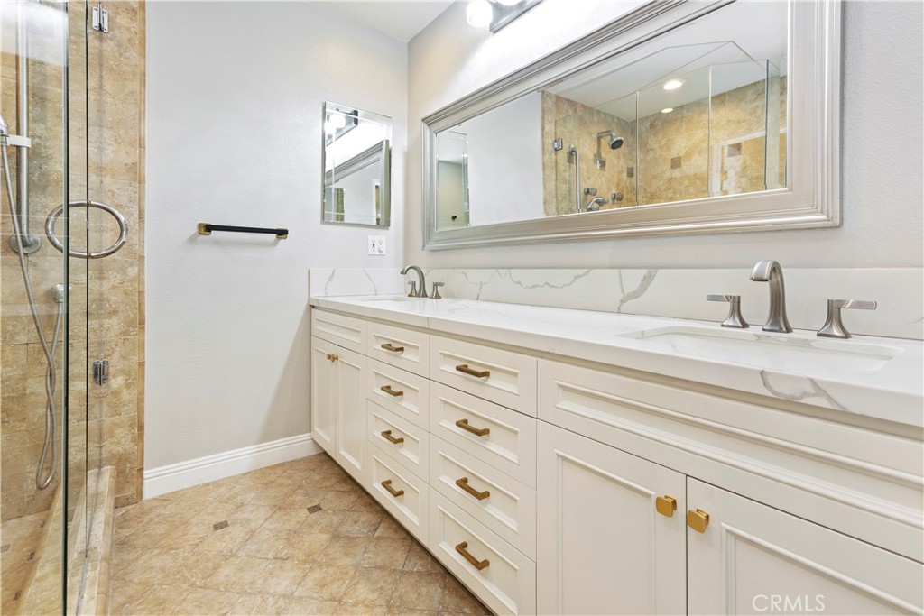38 Racing Wind Irvine, CA 92614 - Photo 16 of 19 a bathroom with a sink a mirror and a shower