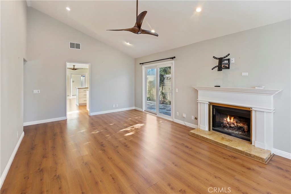 38 Racing Wind Irvine, CA 92614 - Photo 3 of 19 a view of an empty room with wooden floor fireplace and a window