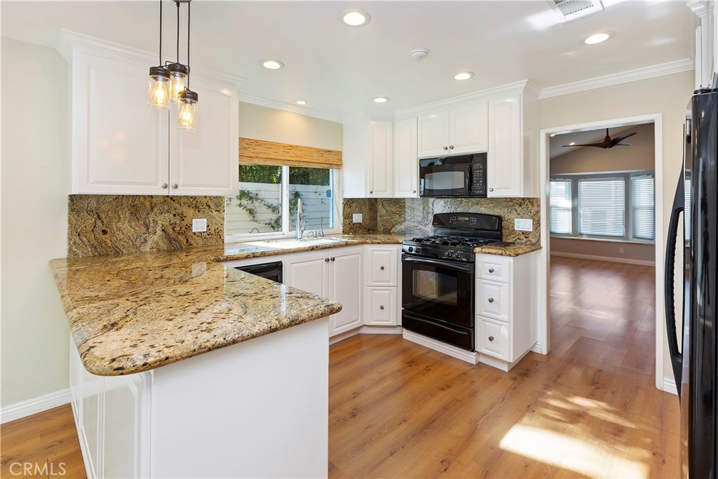 38 Racing Wind Irvine, CA 92614 - Photo 6 of 19 a kitchen with granite countertop stainless steel appliances a stove sink and microwave