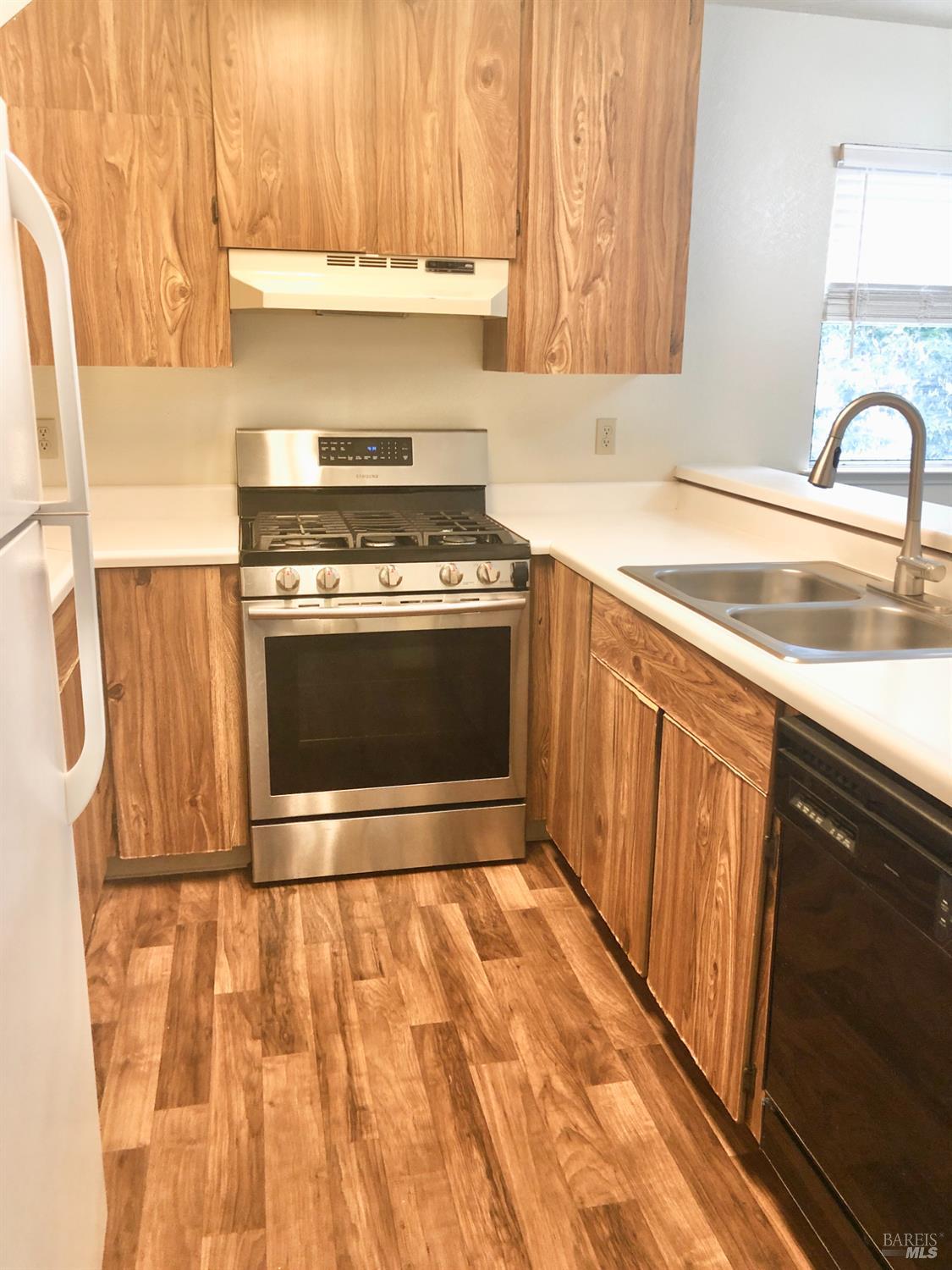 7645 Camino Colegio Rohnert Park, CA 94928 - Photo 5 of 14 a kitchen with a sink stove and cabinets
