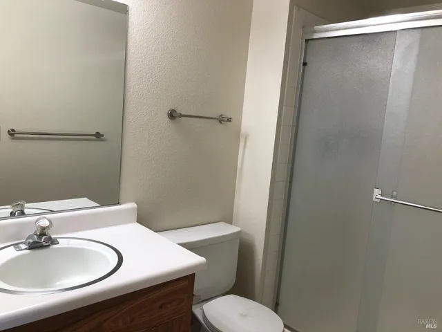 a bathroom with a sink toilet and a mirror