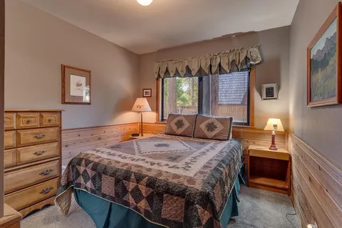 a bedroom with a bed and a dresser