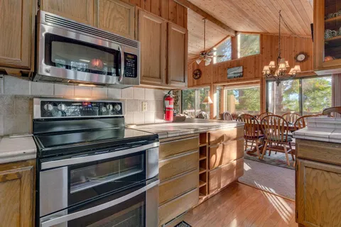 a kitchen with stainless steel appliances a stove a microwave and cabinets