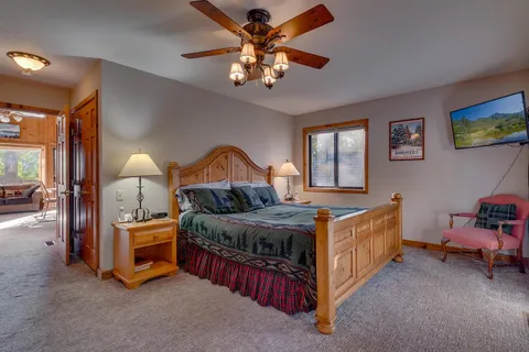 a bedroom with bed and a chandelier