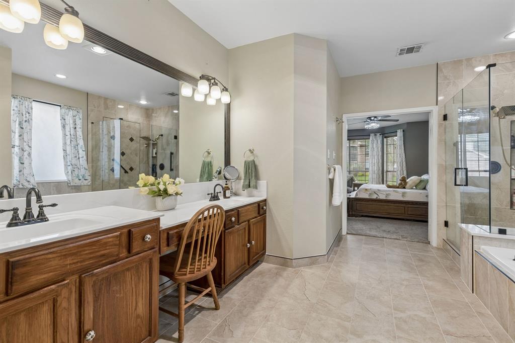 129 Timberbluff Lane Murphy, TX 75094 - Photo 20 of 34 a spacious bathroom with a double vanity sink a mirror and a shower