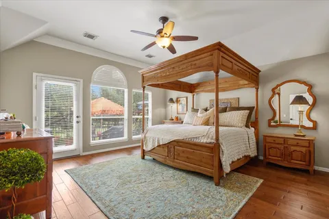 a bedroom with a large bed and a chandelier