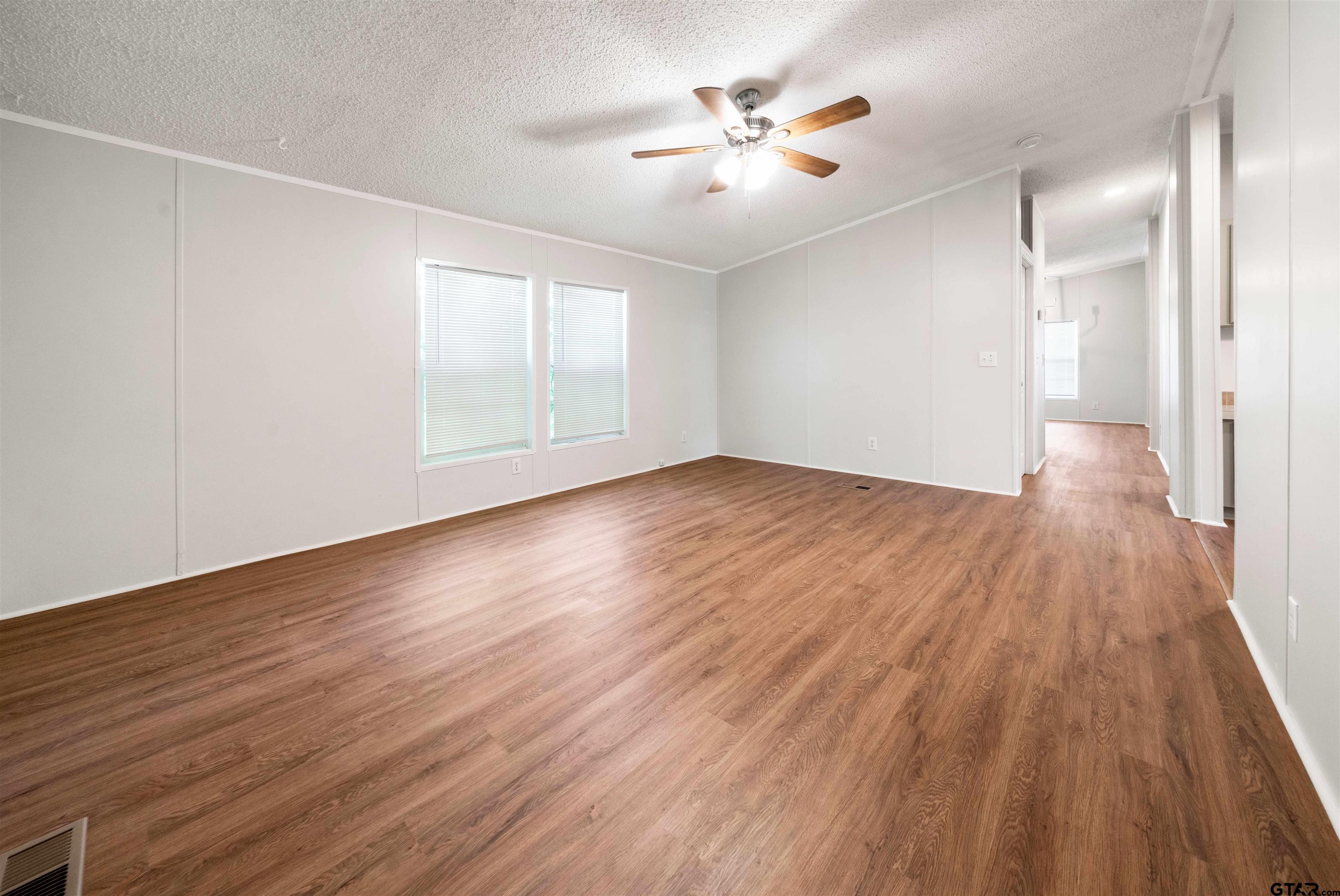 10490 Peterson Tyler, TX 75708 - Photo 12 of 30 an empty room with wooden floor and windows