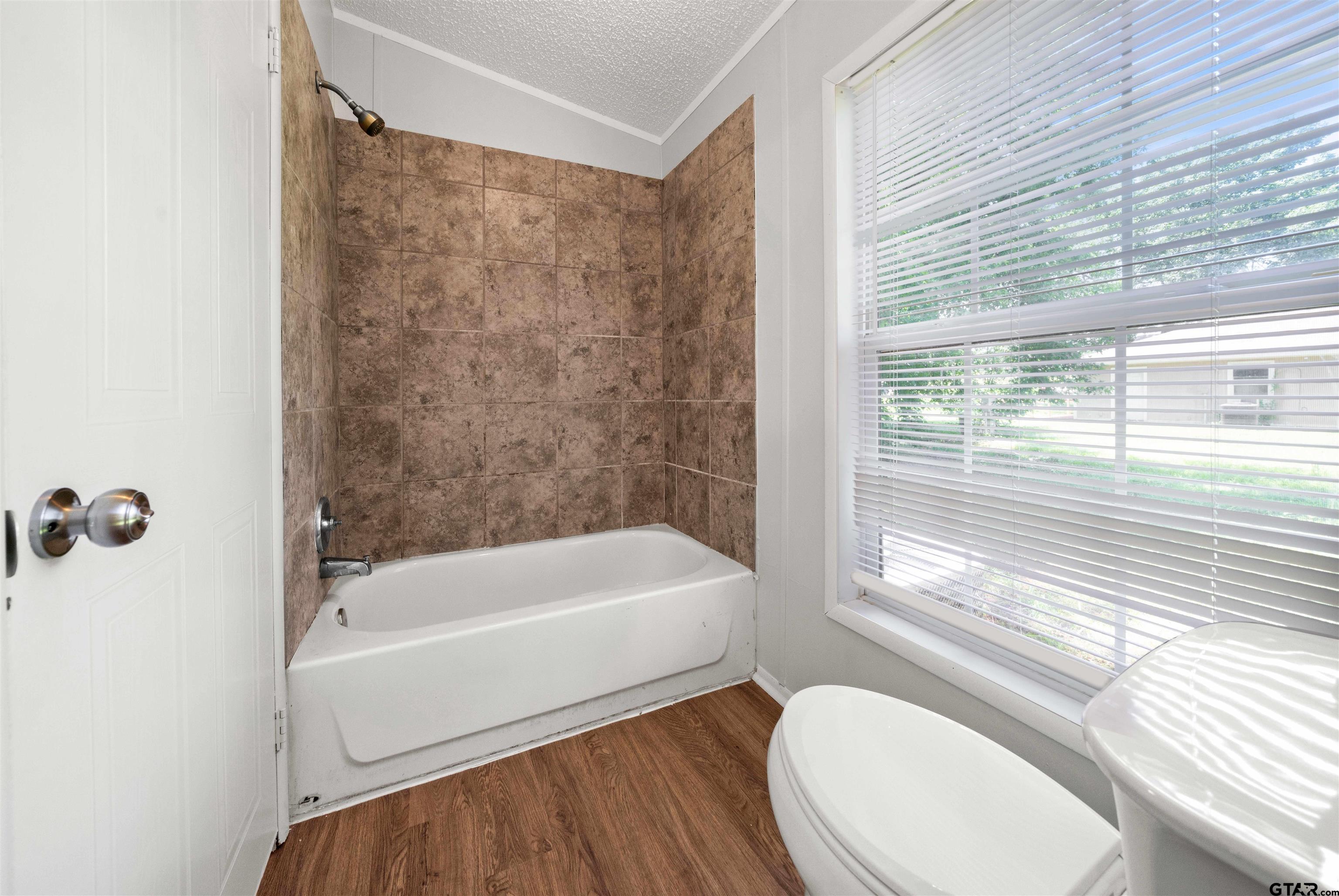 10490 Peterson Tyler, TX 75708 - Photo 16 of 30 a bathroom with a sink a window and a bathtub