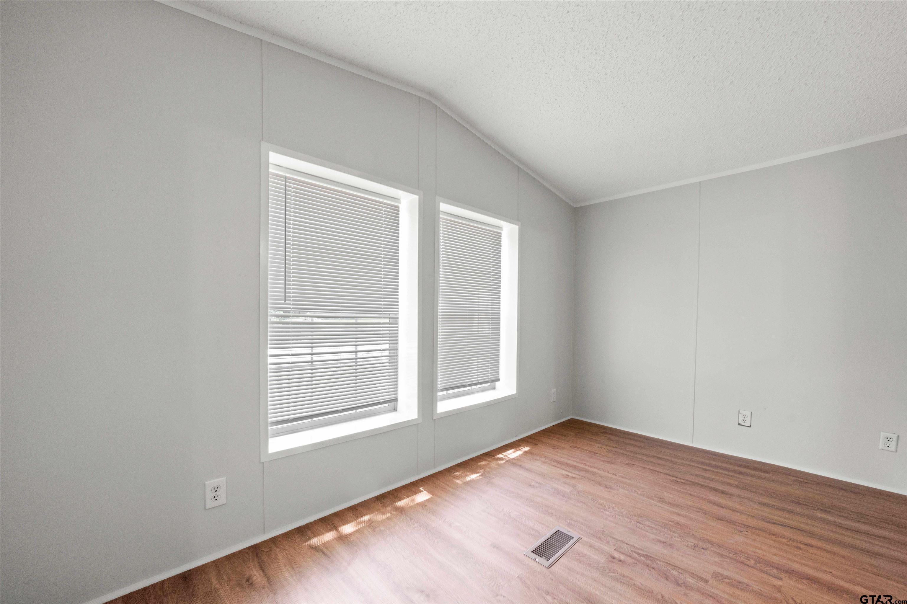 10490 Peterson Tyler, TX 75708 - Photo 18 of 30 an empty room with wooden floor and windows