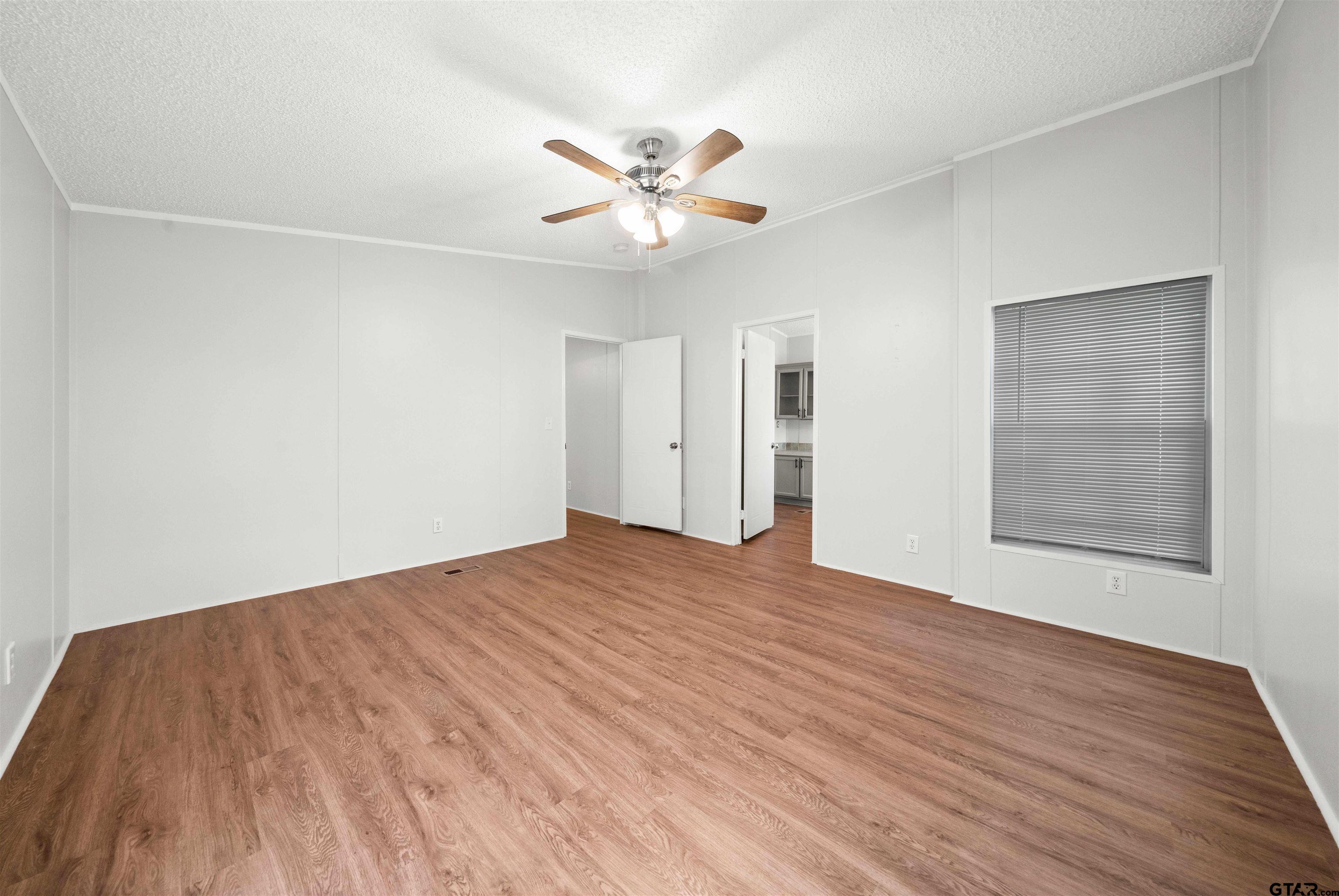10490 Peterson Tyler, TX 75708 - Photo 19 of 30 a view of an empty room with wooden floor and a window