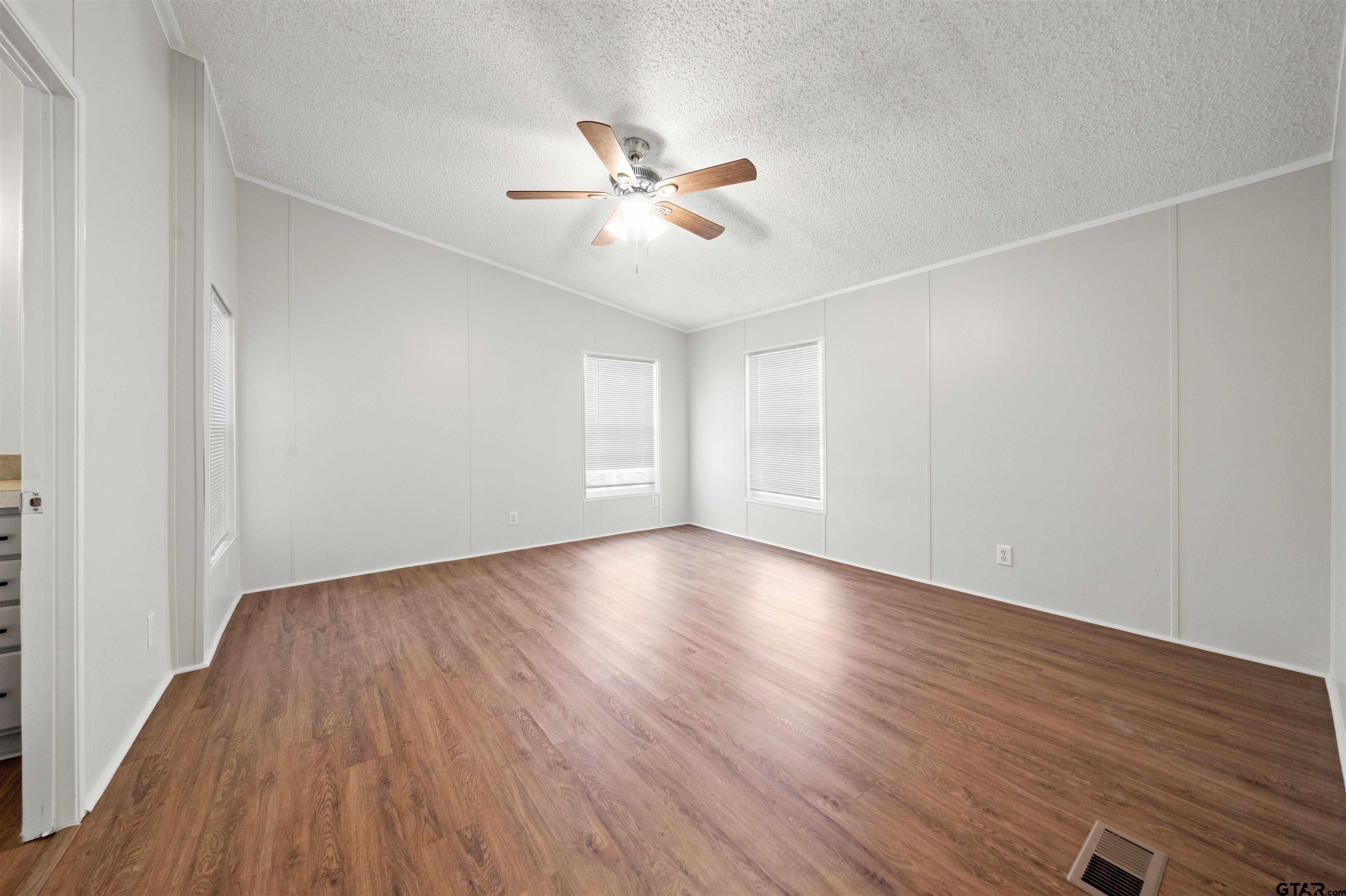 10490 Peterson Tyler, TX 75708 - Photo 20 of 30 an empty room with wooden floor fan and windows