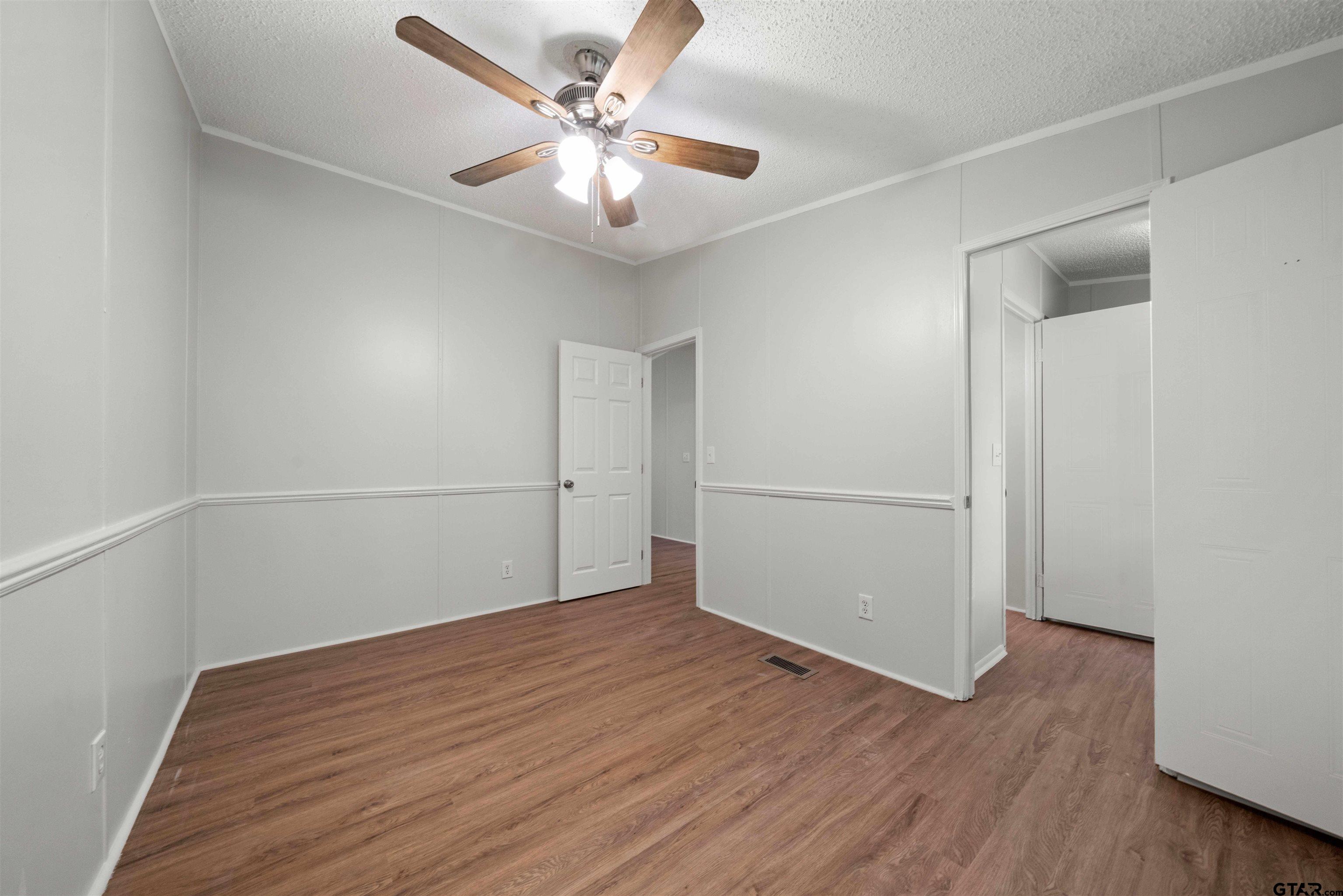 10490 Peterson Tyler, TX 75708 - Photo 23 of 30 an empty room with wooden floor fan and windows