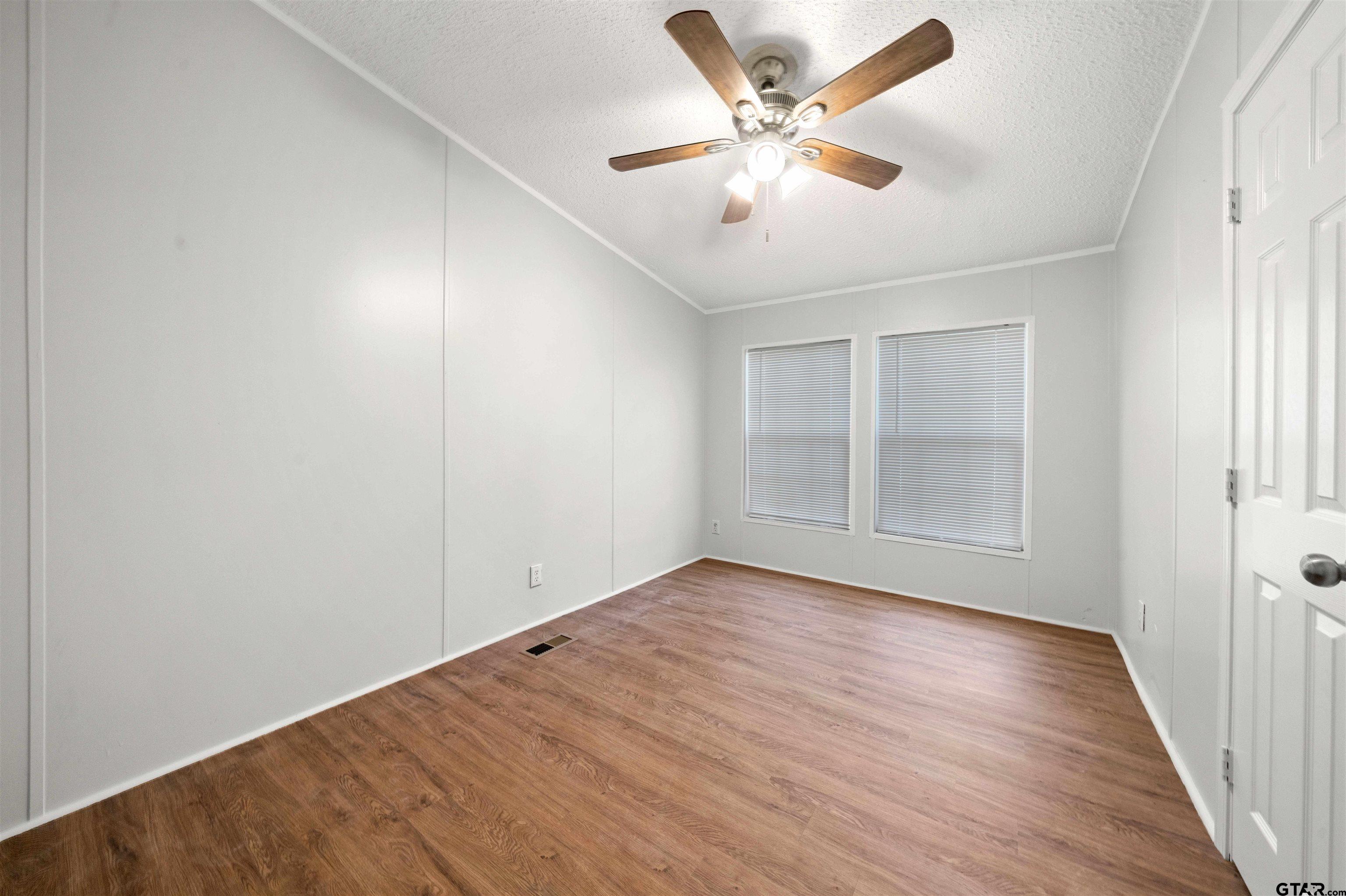 10490 Peterson Tyler, TX 75708 - Photo 25 of 30 an empty room with wooden floor and windows
