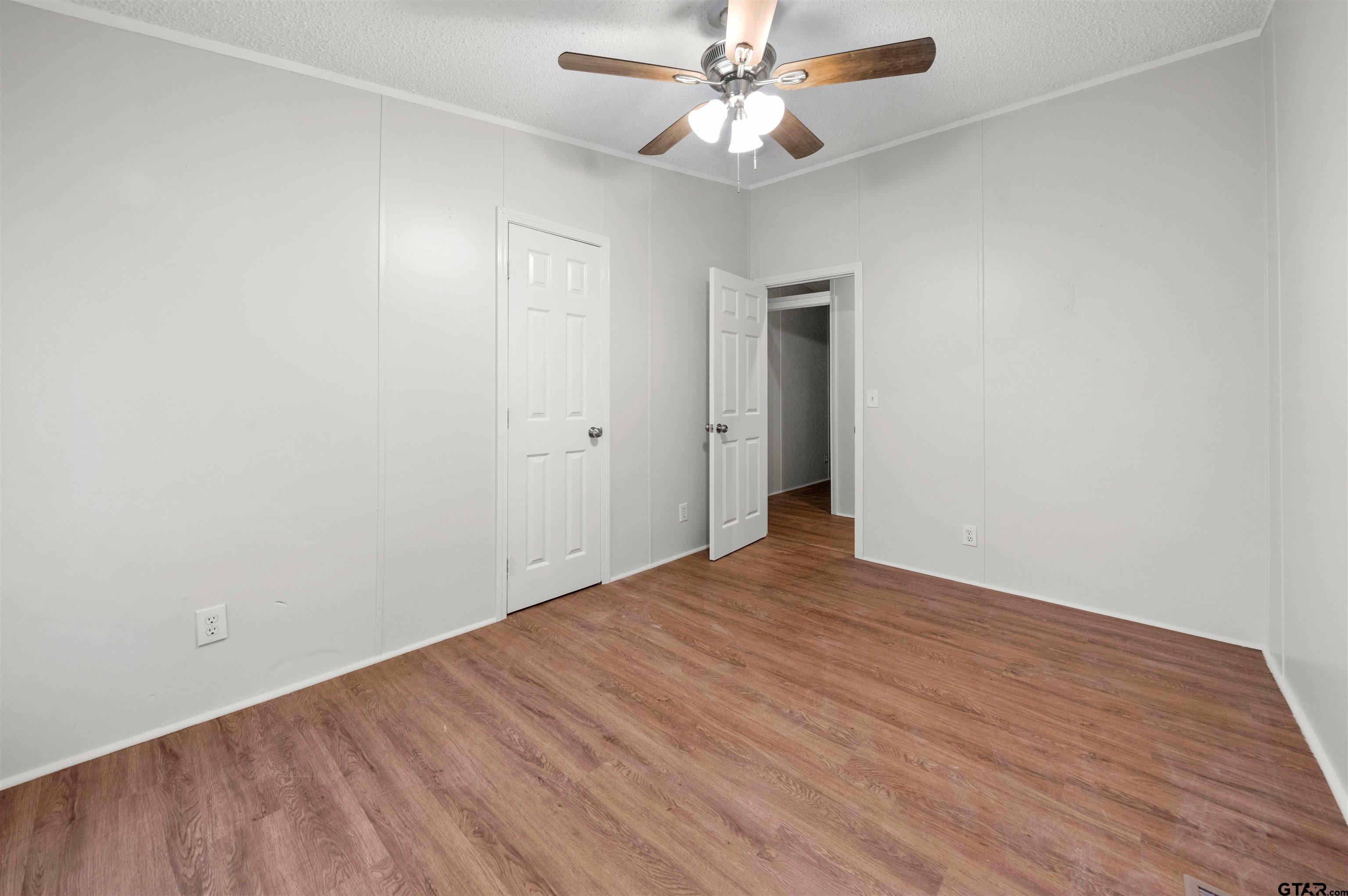 10490 Peterson Tyler, TX 75708 - Photo 26 of 30 an empty room with wooden floor fan and windows