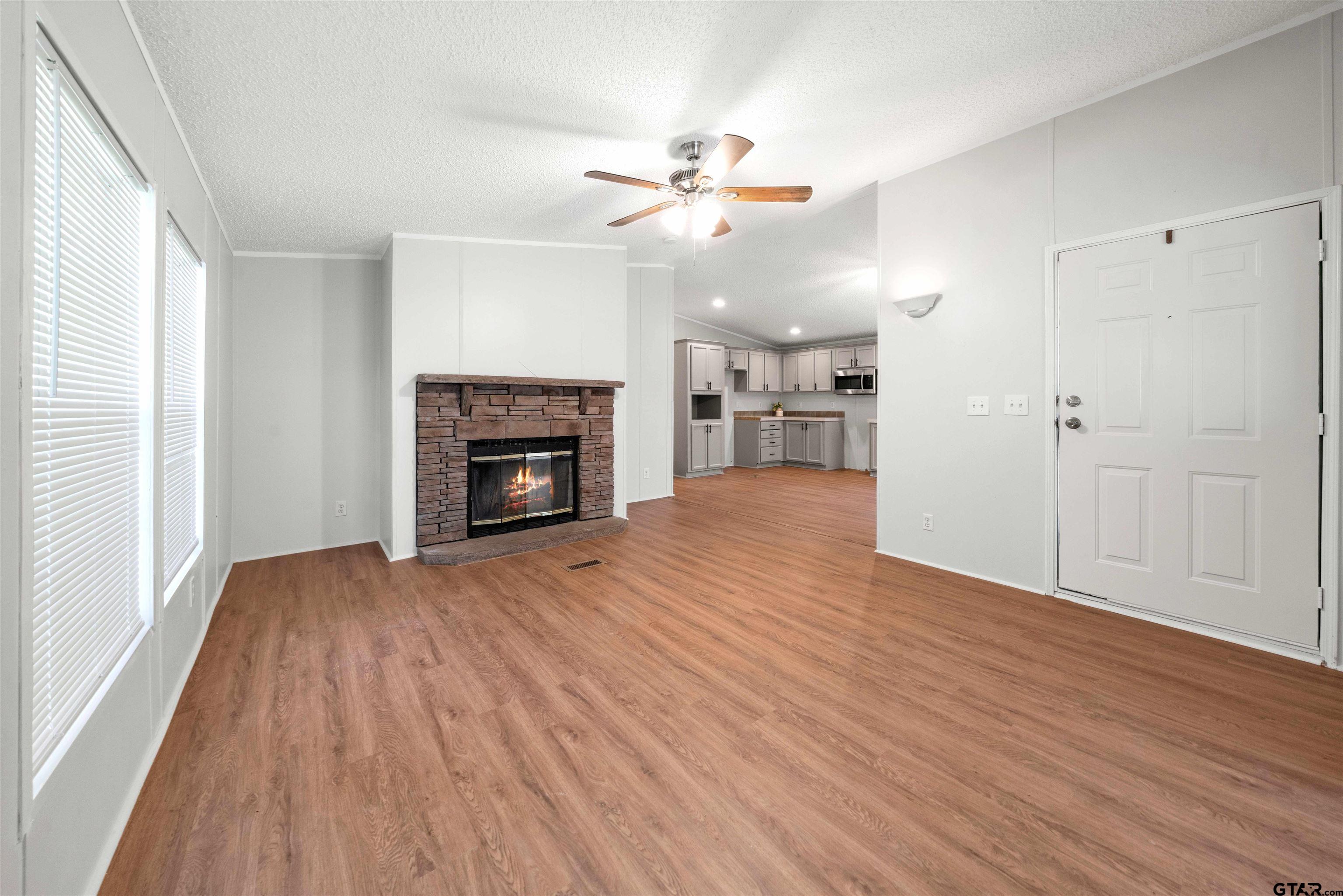 10490 Peterson Tyler, TX 75708 - Photo 5 of 30 a view of an empty room with wooden floor fireplace and a window