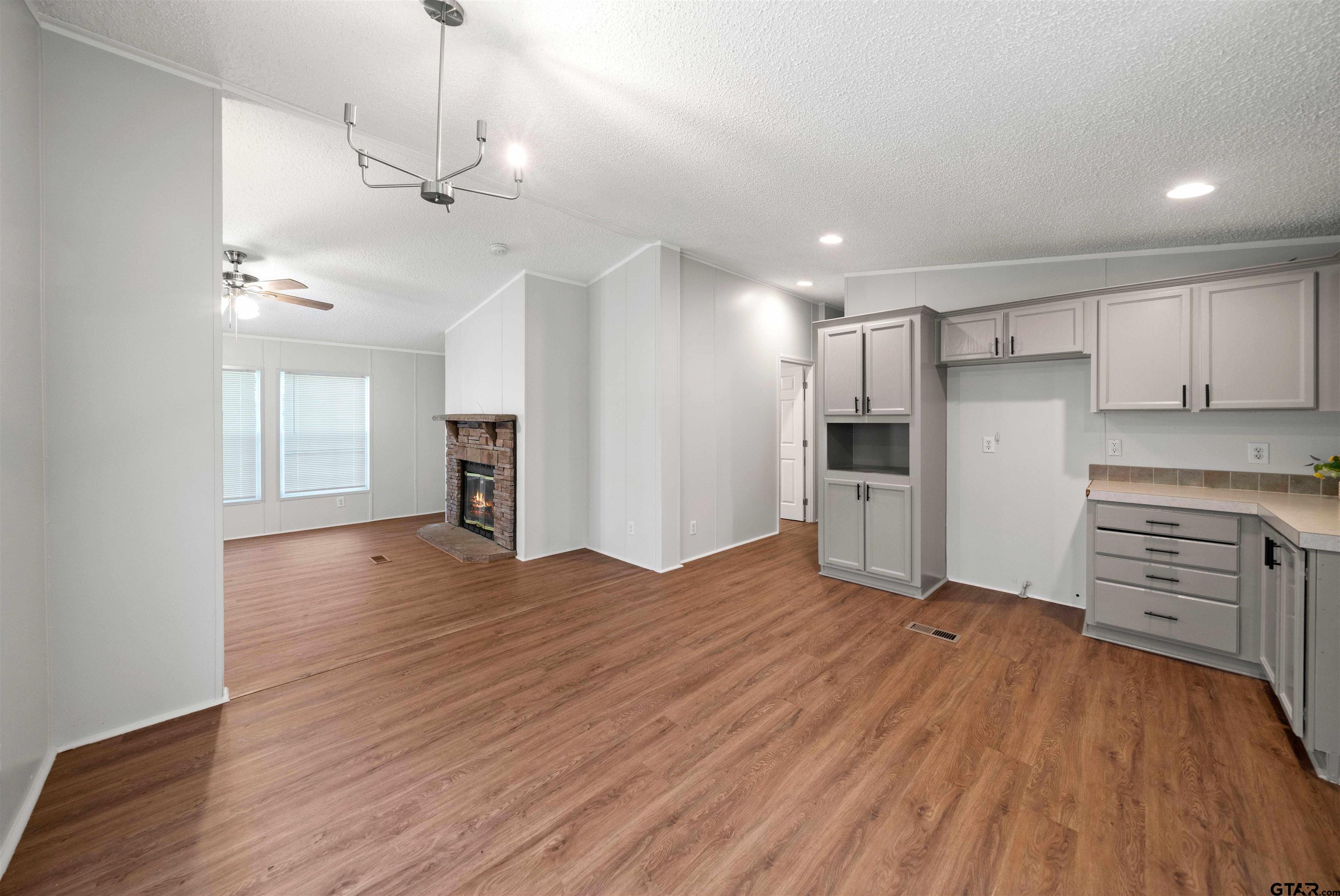 10490 Peterson Tyler, TX 75708 - Photo 7 of 30 a view of a kitchen with a sink and dishwasher a refrigerator with wooden floor