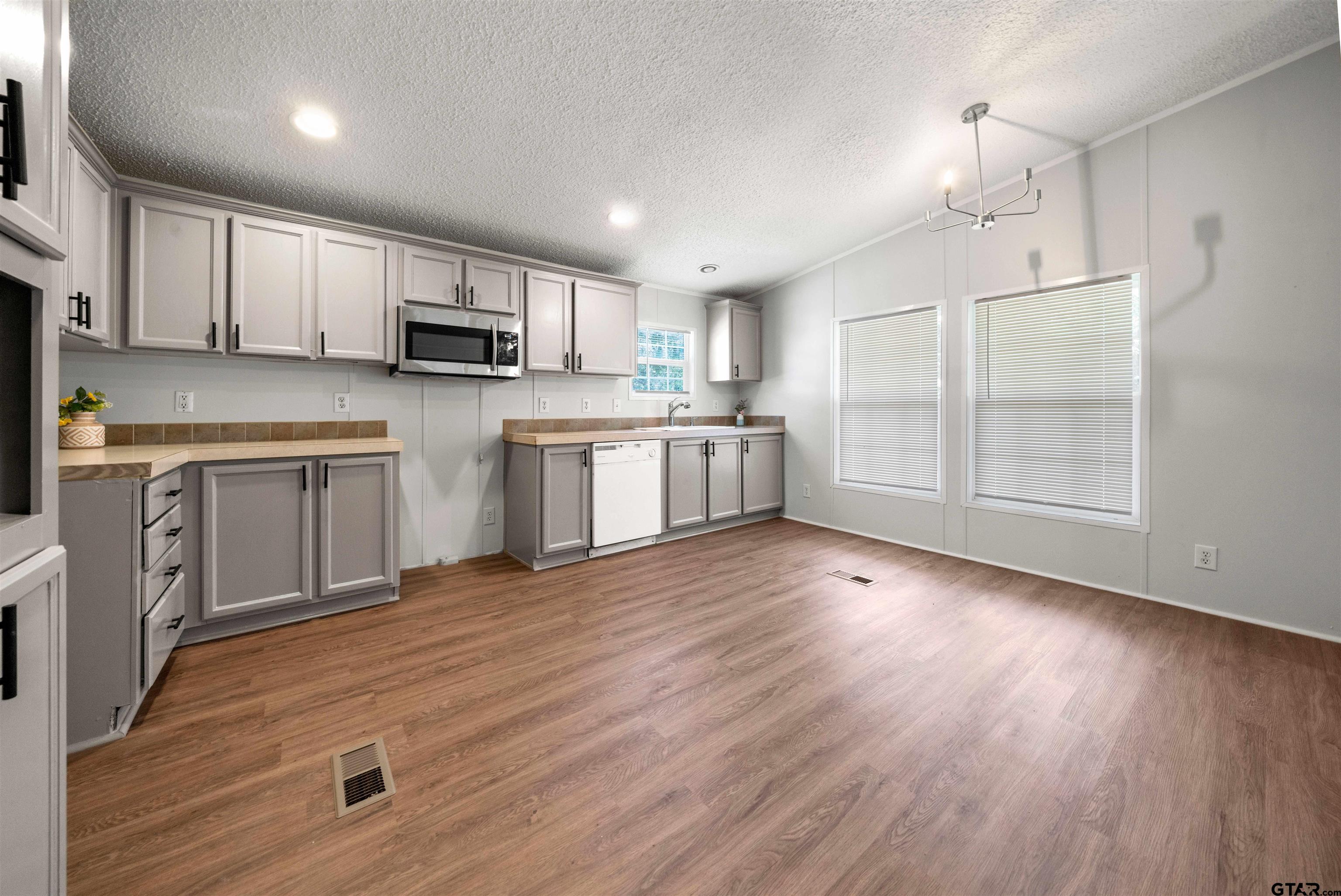 10490 Peterson Tyler, TX 75708 - Photo 9 of 30 a kitchen with cabinets wooden floor and a fireplace