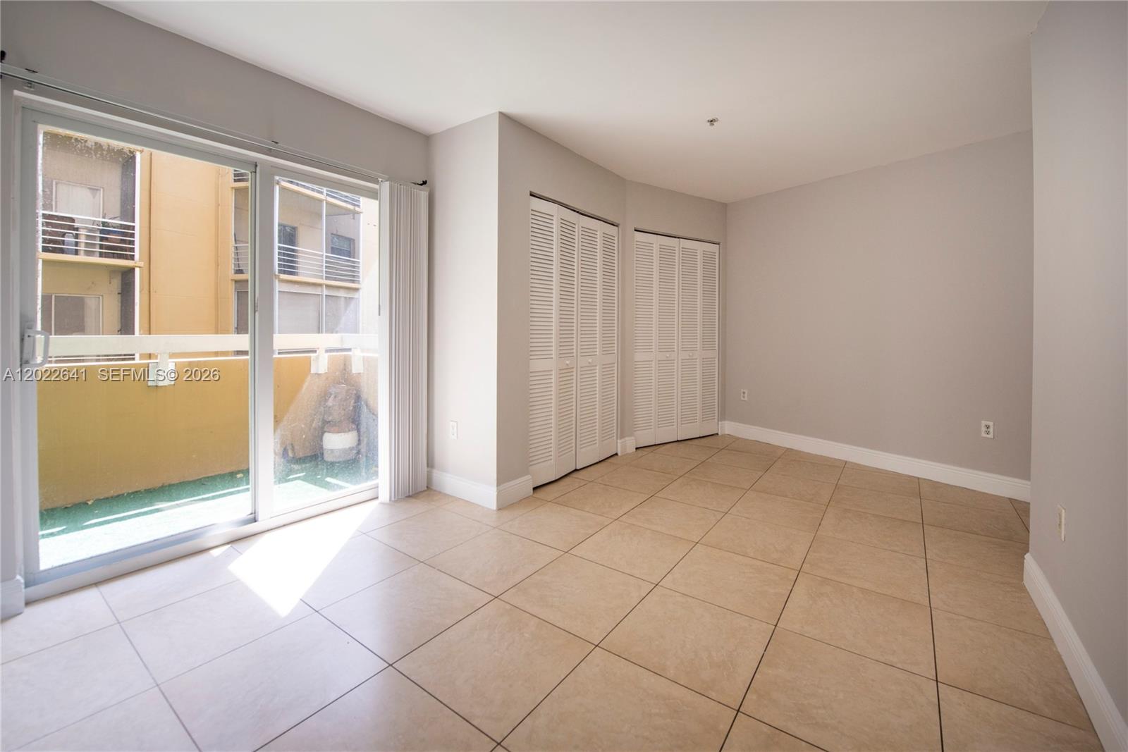 4147 Stirling Road, Unit 105 Dania Beach, FL 33314 - Photo 11 of 16 a view of a livingroom with an empty space and a window