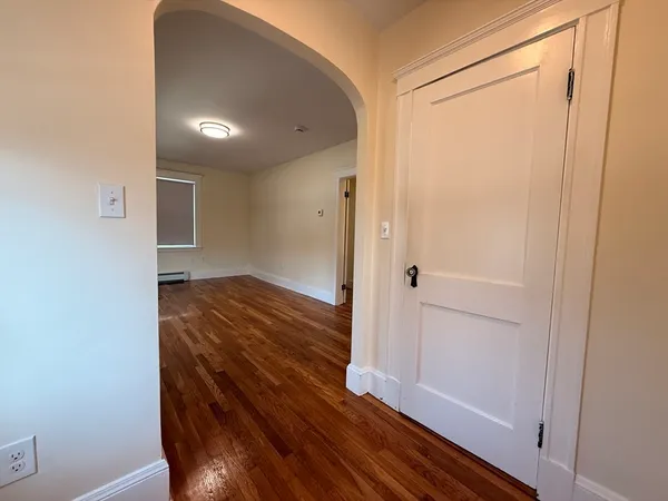 a view of a hallway with wooden floor