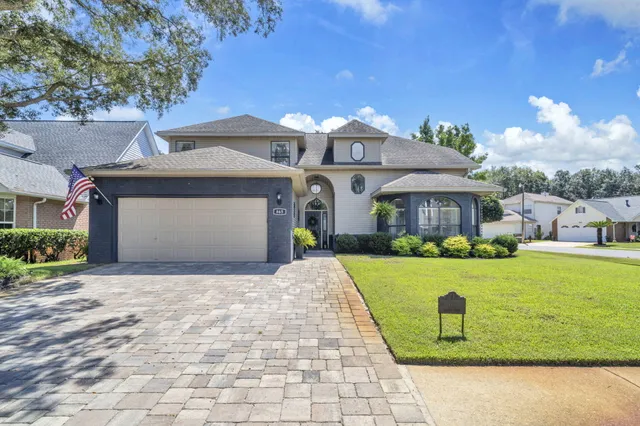 a front view of a house with a garden and yard
