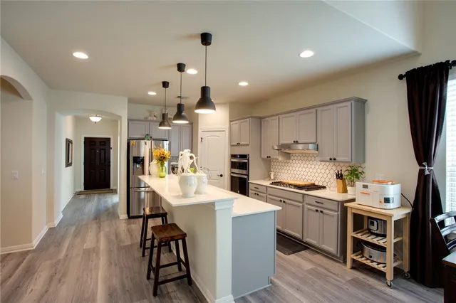 a kitchen with a sink appliances and cabinets